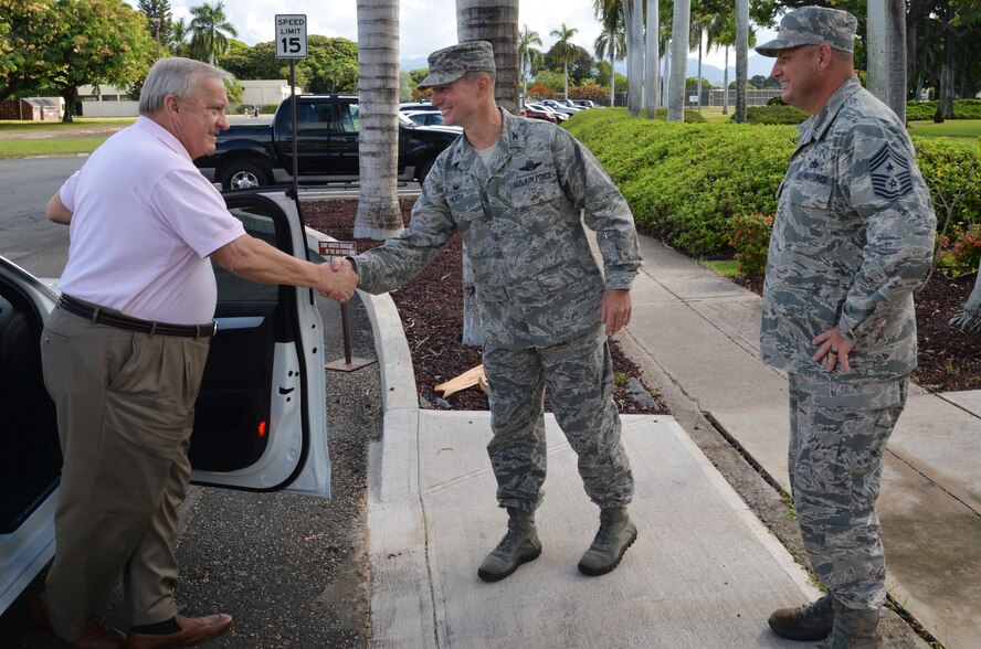 Col. Randy Huiss, 15th Wing commander, and Chief Master Sgt. James Smith, 15th WG command chief, greet Chief Master Sgt. (ret) James C. Binnicker, the ninth Chief Master Sergeant of the Air Force, during his wing headquarters visit Sept. 10, 2014, at Joint Base Pearl Harbor-Hickam, Hawaii. Binnicker toured the 15th WG and Pacific Air Forces for several days before attending the PACAF 67th Birthday Ball as the special guest speaker Sept. 13. (U.S. Air Force photo by Staff Sgt. Alexander Martinez)