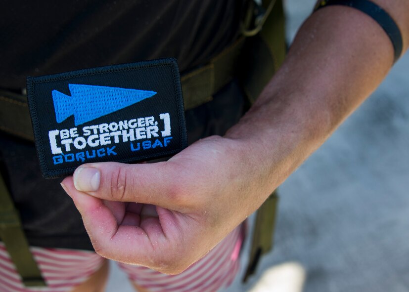 Justine Dechiara receives her patch for completing the GORUCK Cohesion Challenge Sept. 11, at Eglin Air Force Base, Fla.  This elite team-building event, led by a Special Forces veteran, featured military inspired challenges and missions.  Only 24 out of the original 27 completed all obstacles.  Eglin is the fifth base to complete the Team Cohesion Challenge, which is modeled after special operations training.  (U.S. Air Force photo/Tech. Sgt. Jasmin Taylor)