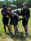 Lyna Camargo gets motivation from her teammates to push through the fireman carry during the GORUCK Cohesion Challenge Sept. 11, at Eglin Air Force Base, Fla.  This elite team-building event, led by a Special Forces veteran, featured military inspired challenges and missions.  Only 24 out of the original 27 completed all obstacles.  Eglin is the fifth base to complete the Team Cohesion Challenge, which is modeled after special operations training.  (U.S. Air Force photo/Tech. Sgt. Jasmin Taylor)