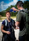 Nick Camargo pours water over his wife, Lyna Camargo, to help cool her off during the GORUCK Cohesion Challenge Sept. 11, at Eglin Air Force Base, Fla.  This elite team-building event, led by a Special Forces veteran, featured military inspired challenges and missions.  Only 24 out of the original 27 completed all obstacles.  Eglin is the fifth base to complete the Team Cohesion Challenge, which is modeled after special operations training.  (U.S. Air Force photo/Tech. Sgt. Jasmin Taylor)