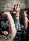 Participants pass a log during the GORUCK Cohesion Challenge Sept. 11, at Eglin Air Force Base, Fla.  This elite team-building event, led by a Special Forces veteran, featured military inspired challenges and missions.  Only 24 out of the original 27 completed all obstacles.  Eglin is the fifth base to complete the Team Cohesion Challenge, which is modeled after special operations training.  (U.S. Air Force photo/Tech. Sgt. Jasmin Taylor)