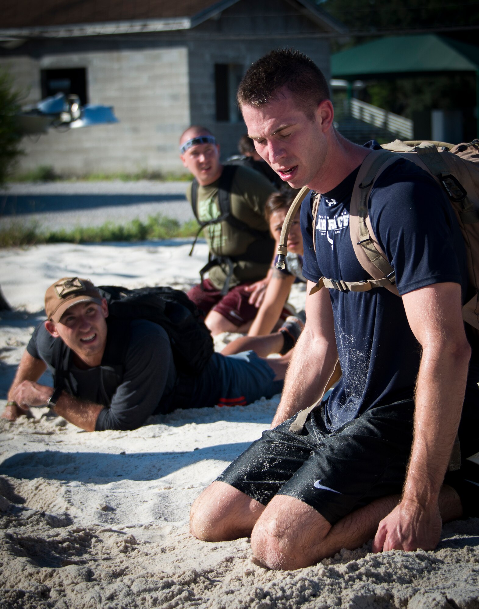 Chad Gibson gets support from his other teammates to keep going during the GORUCK Cohesion Challenge Sept. 11, at Eglin Air Force Base, Fla.  This elite team-building event, led by a Special Forces veteran, featured military inspired challenges and missions.  Only 24 out of the original 27 completed all obstacles.  Eglin is the fifth base to complete the Team Cohesion Challenge, which is modeled after special operations training.  (U.S. Air Force photo/Tech. Sgt. Jasmin Taylor)