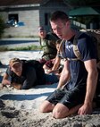 Chad Gibson gets support from his other teammates to keep going during the GORUCK Cohesion Challenge Sept. 11, at Eglin Air Force Base, Fla.  This elite team-building event, led by a Special Forces veteran, featured military inspired challenges and missions.  Only 24 out of the original 27 completed all obstacles.  Eglin is the fifth base to complete the Team Cohesion Challenge, which is modeled after special operations training.  (U.S. Air Force photo/Tech. Sgt. Jasmin Taylor)