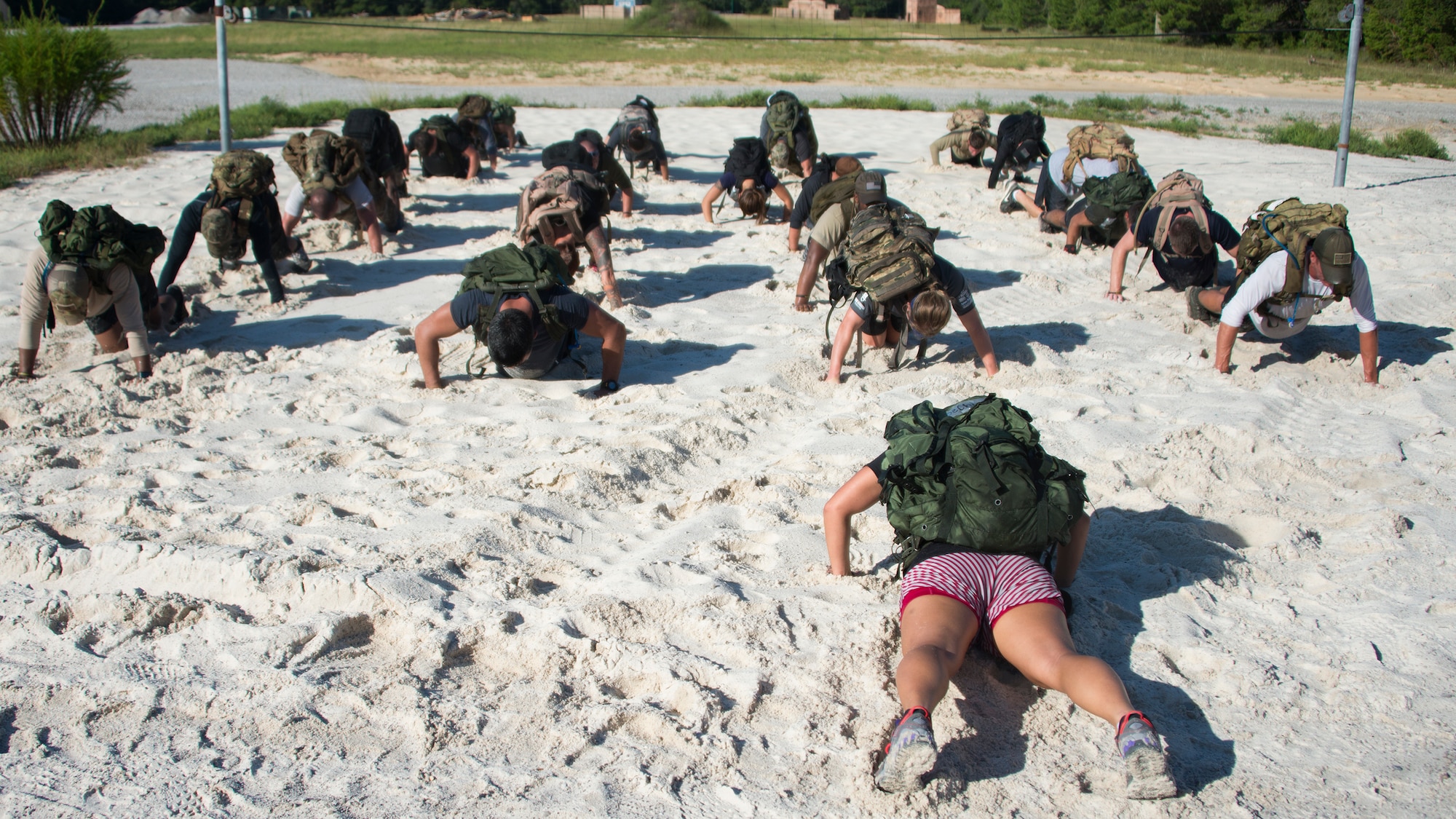 The team leader leads the group in push-ups during the GORUCK Cohesion Challenge Sept. 11, at Eglin Air Force Base, Fla.  This elite team-building event, led by a Special Forces veteran, featured military inspired challenges and missions.  Only 24 out of the original 27 completed all obstacles.  Eglin is the fifth base to complete the Team Cohesion Challenge, which is modeled after special operations training.  (U.S. Air Force photo/Tech. Sgt. Jasmin Taylor)