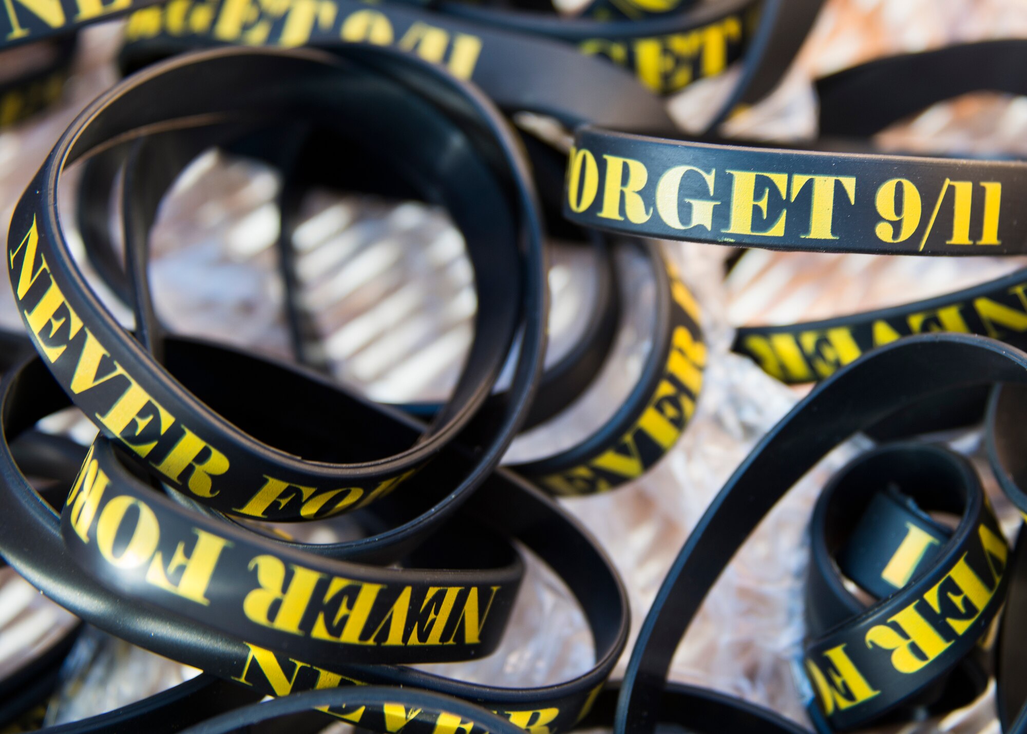 A basket of rubber bracelets with the saying “Never Forget 911” were passed out before the GORUCK Cohesion Challenge Sept. 11, at Eglin Air Force Base, Fla.  This elite team-building event, led by a Special Forces veteran, featured military inspired challenges and missions.  Only 24 out of the original 27 completed all obstacles.  Eglin is the fifth base to complete the Team Cohesion Challenge, which is modeled after special operations training.  (U.S. Air Force photo/Tech. Sgt. Jasmin Taylor)