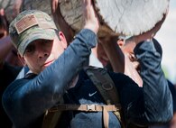 Diego Larmaco carries a log during the GORUCK Cohesion Challenge Sept. 11, at Eglin Air Force Base, Fla.  This elite team-building event, led by a Special Forces veteran, featured military inspired challenges and missions.  Only 24 out of the original 27 completed all obstacles.  Eglin is the fifth base to complete the Team Cohesion Challenge, which is modeled after special operations training.  (U.S. Air Force photo/Tech. Sgt. Jasmin Taylor)