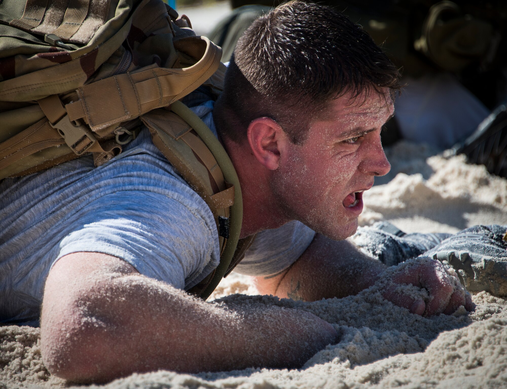 A participant low-crawls through the sand during the GORUCK Cohesion Challenge Sept. 11, at Eglin Air Force Base, Fla.  This elite team-building event, led by a Special Forces veteran, featured military inspired challenges and missions.  Only 24 out of the original 27 completed all obstacles.  Eglin is the fifth base to complete the Team Cohesion Challenge, which is modeled after special operations training.  (U.S. Air Force photo/Tech. Sgt. Jasmin Taylor)