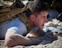 A participant low-crawls through the sand during the GORUCK Cohesion Challenge Sept. 11, at Eglin Air Force Base, Fla.  This elite team-building event, led by a Special Forces veteran, featured military inspired challenges and missions.  Only 24 out of the original 27 completed all obstacles.  Eglin is the fifth base to complete the Team Cohesion Challenge, which is modeled after special operations training.  (U.S. Air Force photo/Tech. Sgt. Jasmin Taylor)