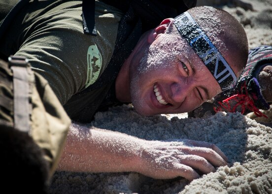 Thamas Church low crawls through the sand during the GORUCK Cohesion Challenge Sept. 11, at Eglin Air Force Base, Fla.  This elite team-building event, led by a Special Forces veteran, featured military inspired challenges and missions.  Only 24 out of the original 27 completed all obstacles.  Eglin is the fifth base to complete the Team Cohesion Challenge, which is modeled after special operations training.  (U.S. Air Force photo/Tech. Sgt. Jasmin Taylor)