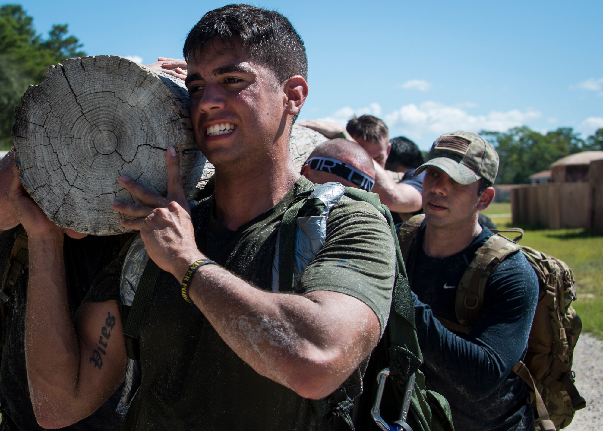 Nick Camargo and his team carry a log during the GORUCK Cohesion Challenge Sept. 11, at Eglin Air Force Base, Fla.  This elite team-building event, led by a Special Forces veteran, featured military inspired challenges and missions.  Only 24 out of the original 27 completed all obstacles.  Eglin is the fifth base to complete the Team Cohesion Challenge, which is modeled after special operations training.  (U.S. Air Force photo/Tech. Sgt. Jasmin Taylor)