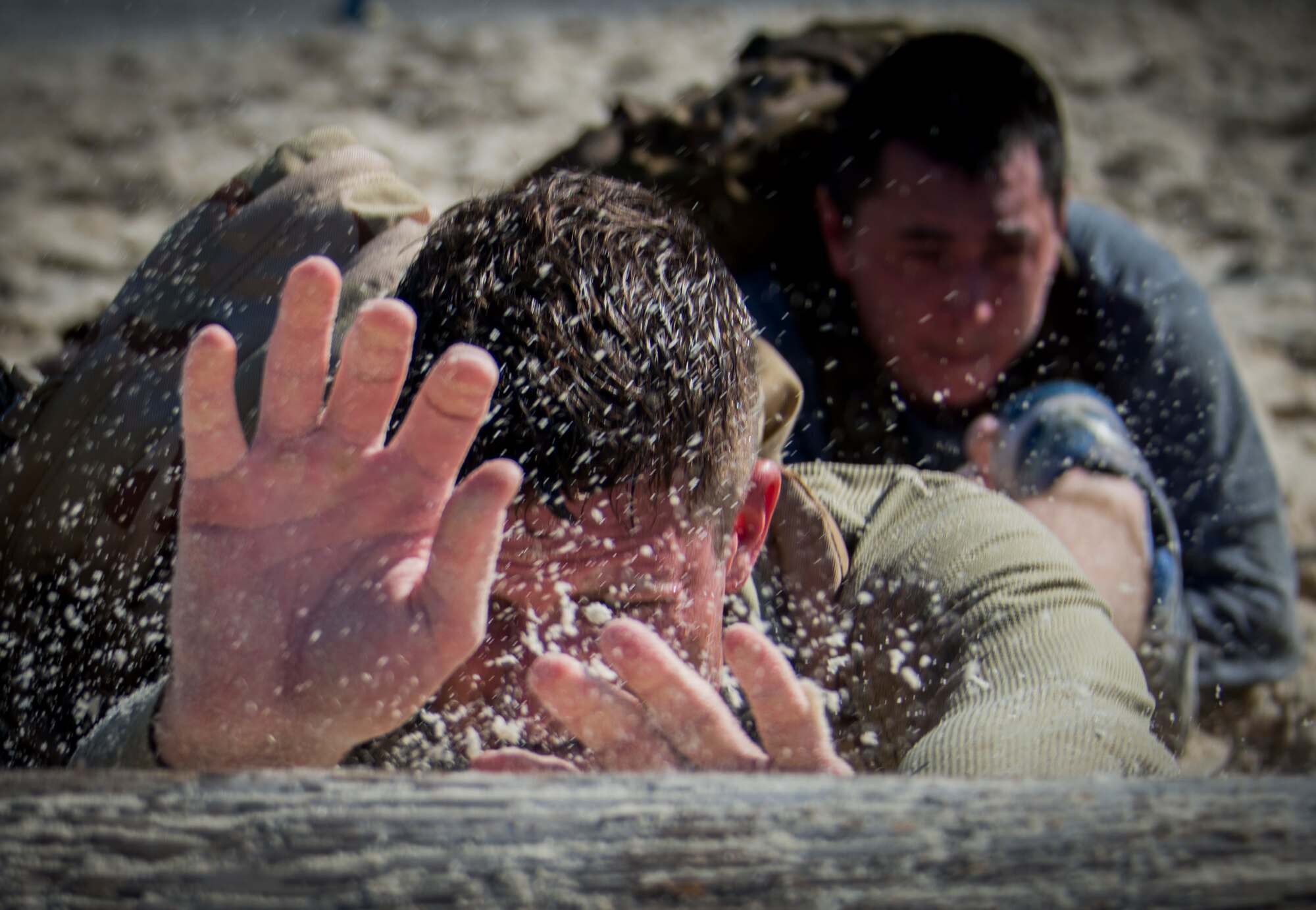 Participants push a log through an obstacle during the GORUCK Cohesion Challenge Sept. 11, at Eglin Air Force Base, Fla.  This elite team-building event, led by a Special Forces veteran, featured military inspired challenges and missions.  Only 24 out of the original 27 completed all obstacles.  Eglin is the fifth base to complete the Team Cohesion Challenge, which is modeled after special operations training.  (U.S. Air Force photo/Tech. Sgt. Jasmin Taylor)