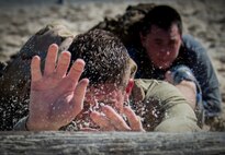 Participants push a log through an obstacle during the GORUCK Cohesion Challenge Sept. 11, at Eglin Air Force Base, Fla.  This elite team-building event, led by a Special Forces veteran, featured military inspired challenges and missions.  Only 24 out of the original 27 completed all obstacles.  Eglin is the fifth base to complete the Team Cohesion Challenge, which is modeled after special operations training.  (U.S. Air Force photo/Tech. Sgt. Jasmin Taylor)