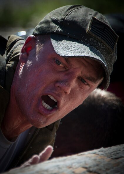 Colten Ederer pushes a log during the GORUCK Cohesion Challenge Sept. 11, at Eglin Air Force Base, Fla.  This elite team-building event, led by a Special Forces veteran, featured military inspired challenges and missions.  Only 24 out of the original 27 completed all obstacles.  Eglin is the fifth base to complete the Team Cohesion Challenge, which is modeled after special operations training.  (U.S. Air Force photo/Tech. Sgt. Jasmin Taylor)