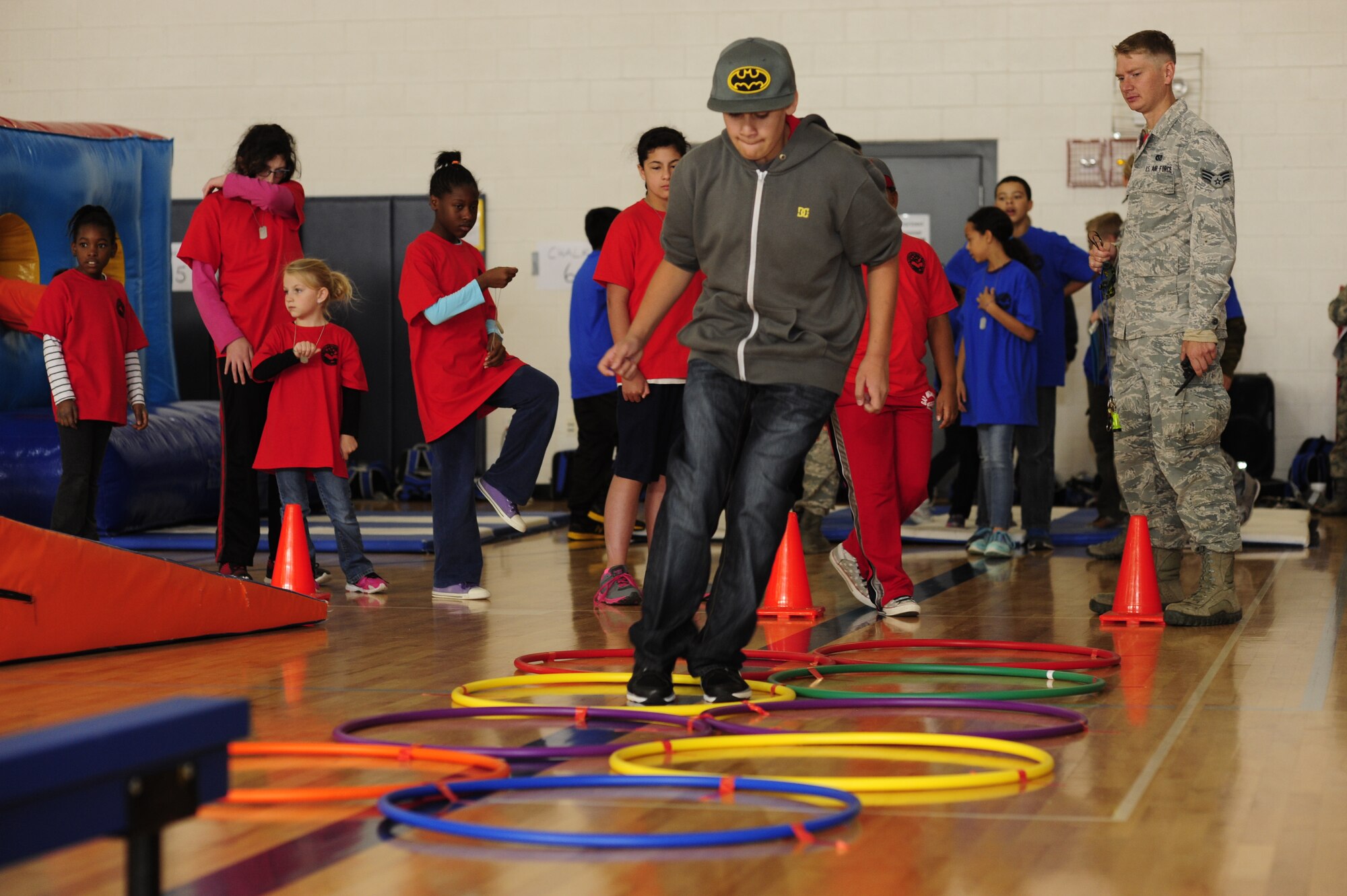 A child jumps through hula-hoops during the Operation Future Forces event Sept. 13, 2014, at the youth center on Buckley Air Force Base, Colo. During OFF, children were given the chance to experience what a military member endures from “Basic Military Training” to a mock deployment. (U.S. Air Force photo by Airman 1st Class Samantha Saulsbury/Released))