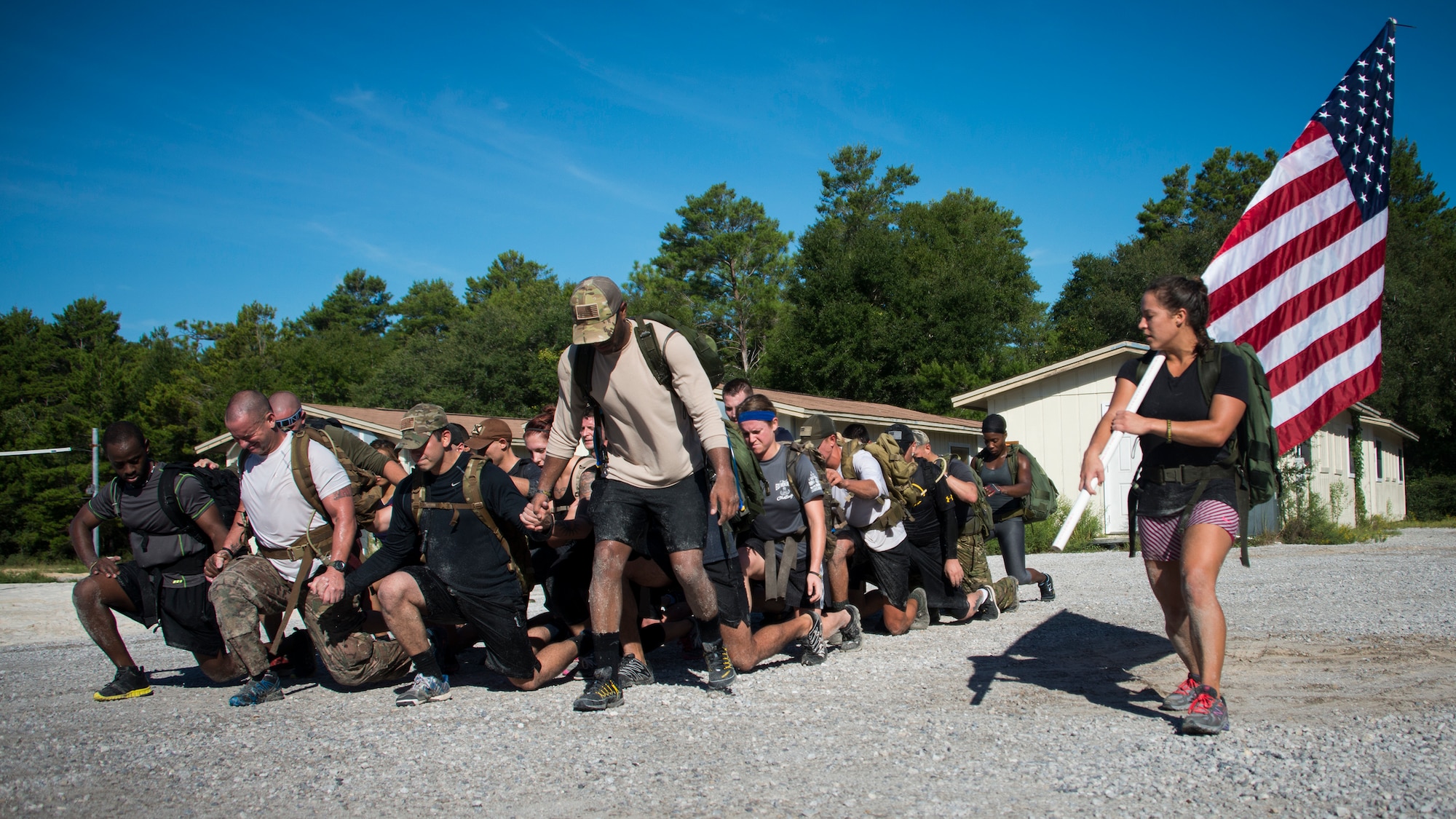 Members perform team lunges as part of the GORUCK Cohesion Challenge Sept. 11, at Eglin Air Force Base, Fla.  This elite team-building event, led by a Special Forces veteran, featured military inspired challenges and missions.  Only 24 out of the original 27 completed all obstacles.  Eglin is the fifth base to complete the Team Cohesion Challenge.  (U.S. Air Force photo/Tech. Sgt. Jasmin Taylor)