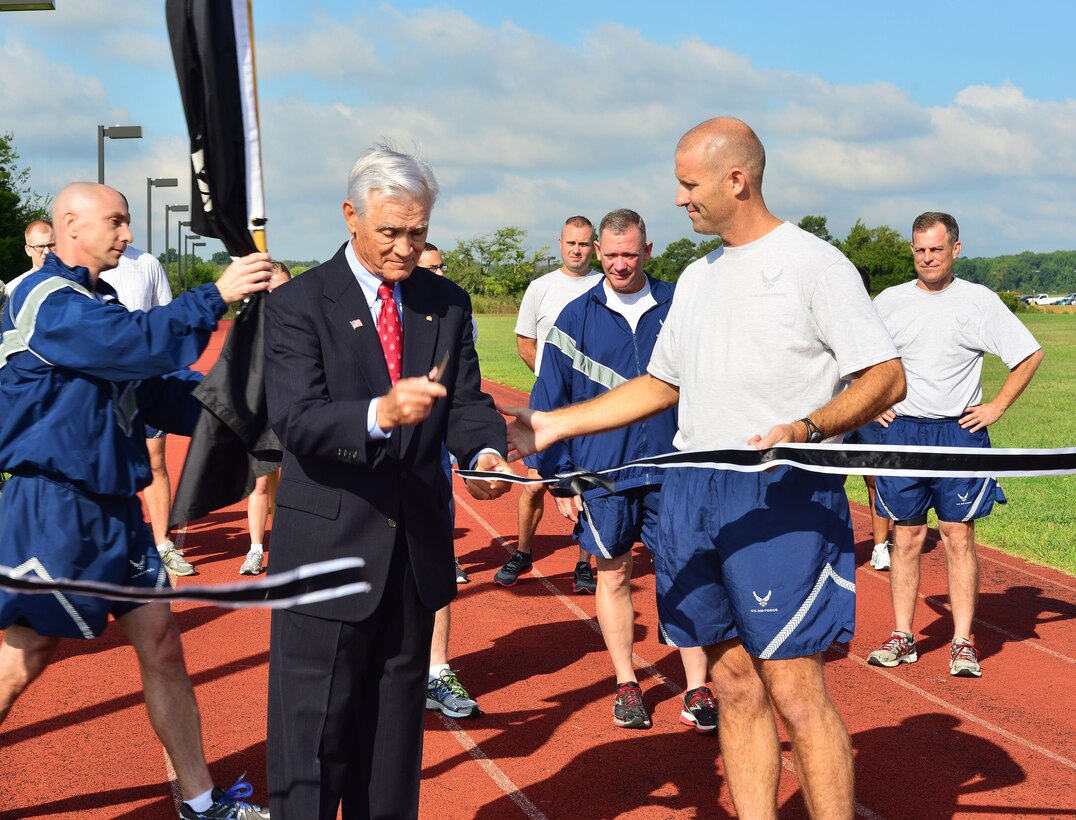 U.S. Air Force Lt. Col. (Ret.) Barry Bridger, North Vietnam Prisoner of War survivor and Col. Kevin Huyck 1st Fighter Wing commander, cut a ribbon at the start of the 2014 POW/MIA 24-hour vigil at Langley Air Force Base, Va., Sept. 16, 2014. Over the next couple of days, Bridger will share his story with the Joint Base Langley-Eustis community. (U.S. Air Force photo by Staff Sgt. Antoinette Gibson/Released)