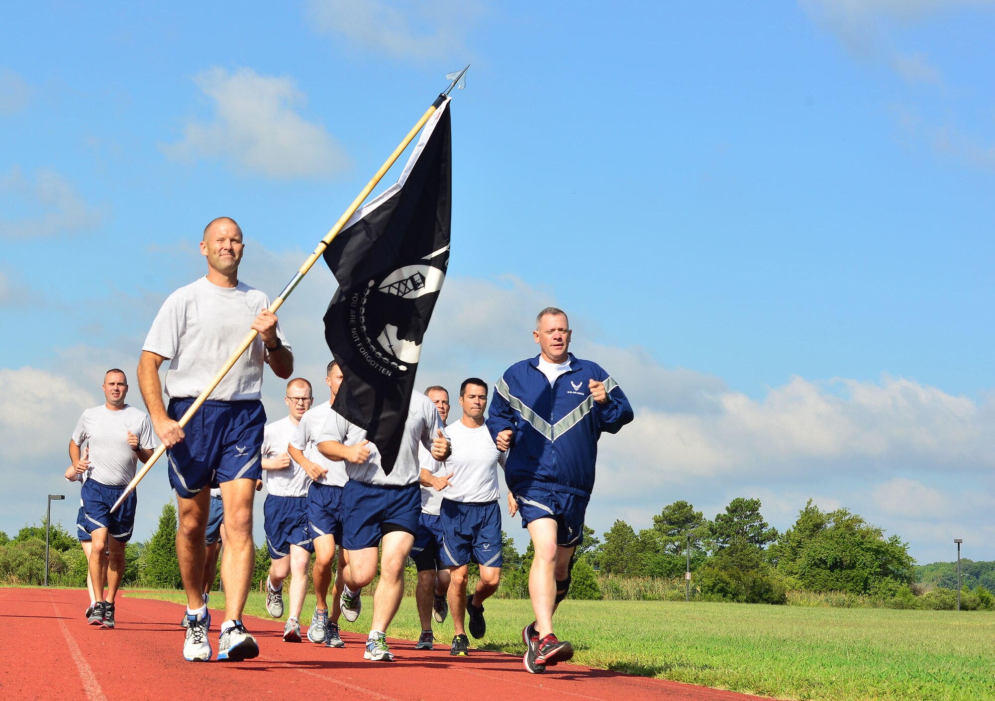 U.S. Air Force Col. Kevin Huyck 1st Fighter Wing commander, leads Airmen to the finish line at the 2014 POW/MIA 24-hour vigil at Langley Air Force Base, Va., Sept. 16, 2014. The walk was part of several events to be held throughout the week in honor of our nation’s POW/MIA Service members. (U.S. Air Force photo by Staff Sgt. Antoinette Gibson/Released)