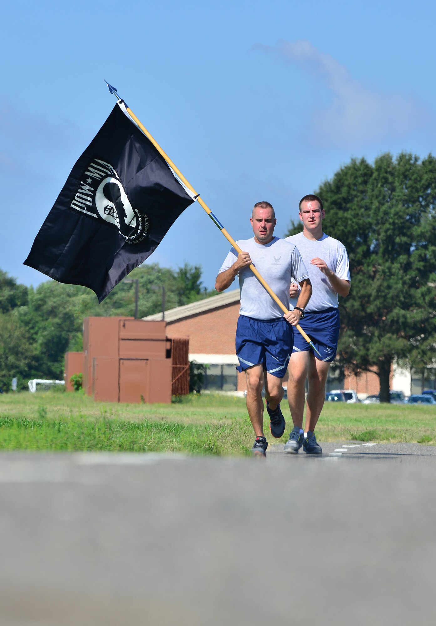 U.S. Air Force Tech Sgt. Russell Oswalt, 1st Fighter Wing command chief’s executive assistant, and Staff Sgt. Trevor Selleck, 1st Operations Support Squadron intelligence analyst, head for the finish line during a POW/MIA 24-hour run/walk at Langley Air Force Base, Va., Sept. 16, 2014. The vigil held was held to honor the nation’s prisoner of war and missing in action Service members.  (U.S. Air Force photo by Staff Sgt. Antoinette Gibson/Released)
