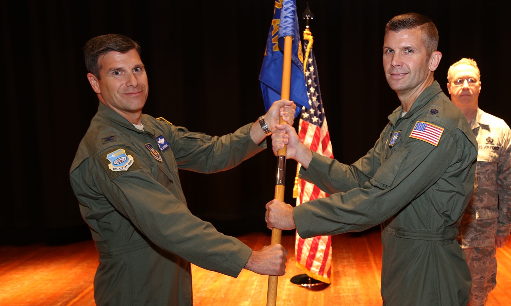 Outgoing 932nd Airlift Wing commander, Col. Albert Lupenski, gives the flag to the incoming 932nd Operations Group commander, Lt. Col. Sean Pierce during a ceremony at Scott Air Force Base.  (U.S. Air Force photo/Tech. Sgt. Chris Parr)