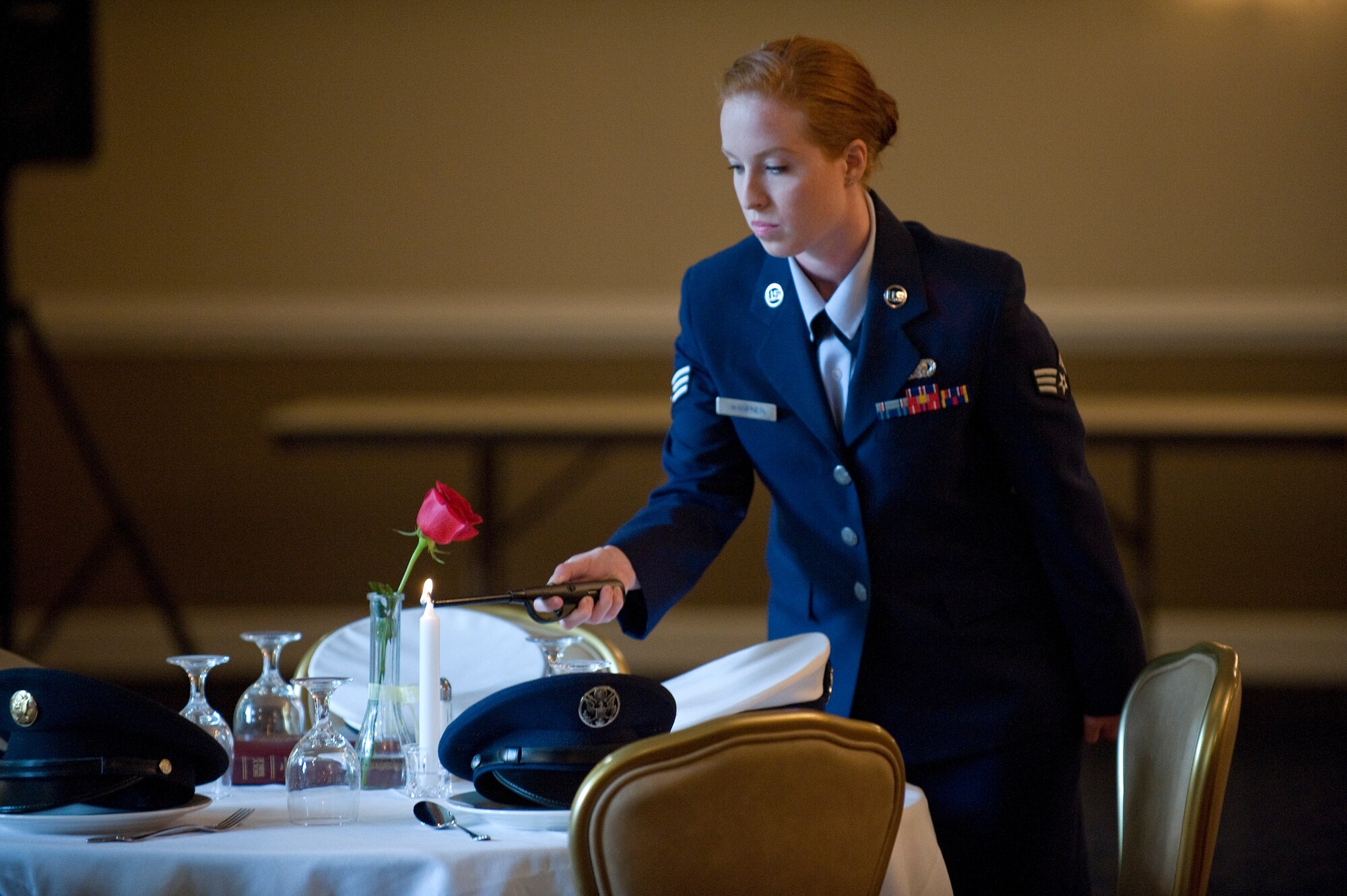 Senior Airman Christin Wampner, 4th Logistics Readiness Squadron, lights the candle during a lighting ceremony in honor of prisoners of war and service members missing in action Sept. 15 at Seymour Johnson Air Force Base, North Carolina. The 4th Fighter Wing is holding several events Sept. 15 through 19 honoring prisoners of war and service members missing in action. The base will close out its POW/MIA week with a ceremony Sept. 19, held in conjunction with National POW/MIA Recognition Day, at Heritage Park at 4 p.m.  (U.S. Air Force photo/Airman 1st Class Aaron J. Jenne)