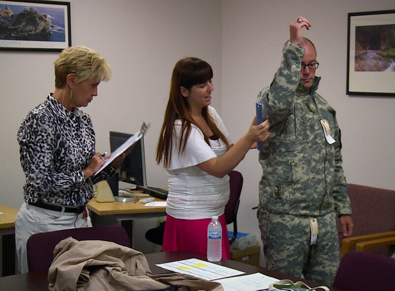 Kristina Dodds (left) and Andrea Pardue, clothing designers in the Air Force Uniform Office at Wright-Patterson AFB, Ohio, fit test an Airman trying on the new Cold Weather Aviation System. The request is to develop a flame-resistant system that can also keep aircrews warm in 20-below-zero temperatures with a 55-mph wind. (U.S. Air Force photo/Matthew Clouse)