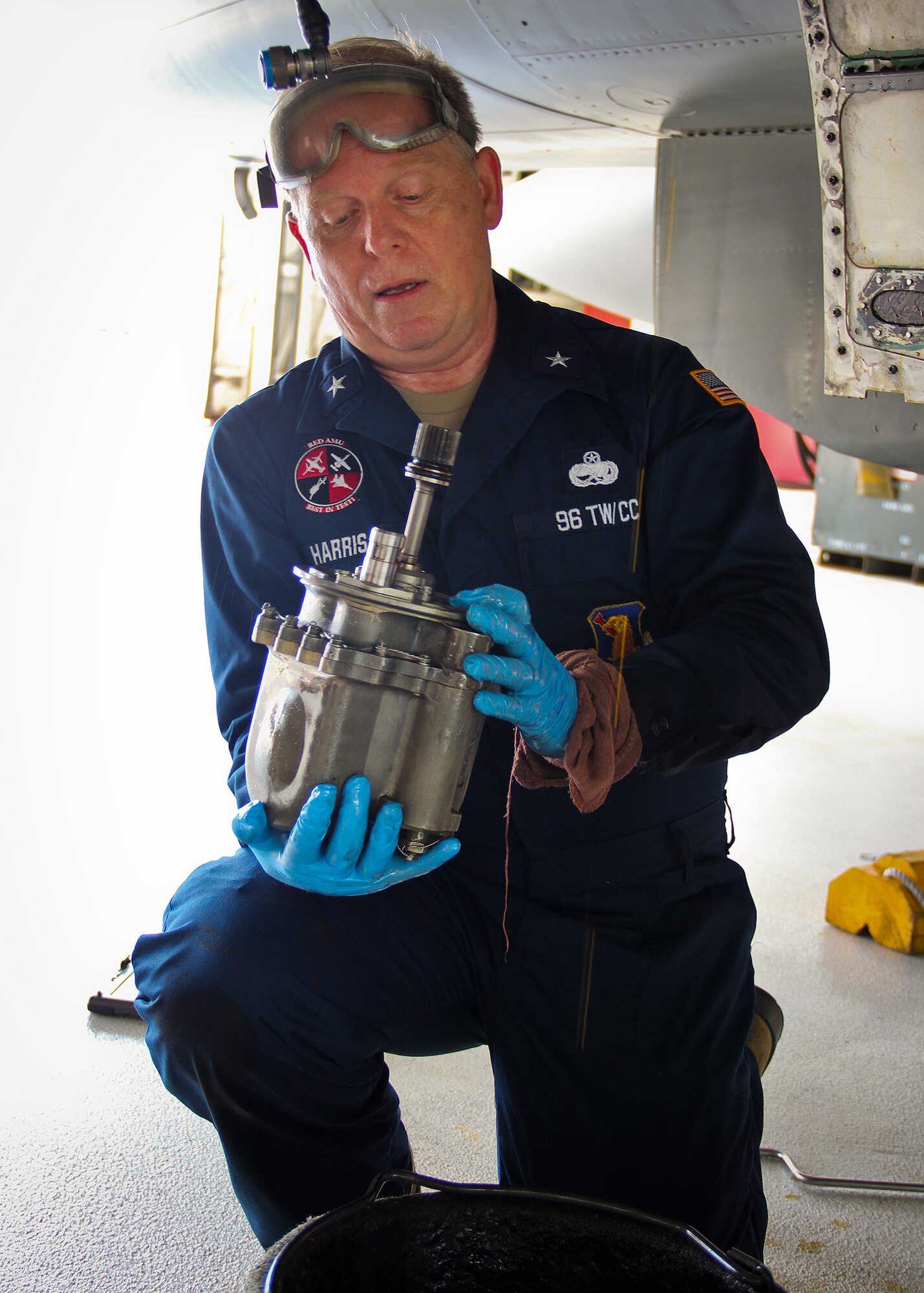 Brig. Gen. David Harris, 96th Test Wing commander, holds a PC-1 hydraulic pump he helped wing maintainers remove from an F-15 Eagle Sept. 15 at Eglin Air Force Base, Fla.  (Courtesy photo)