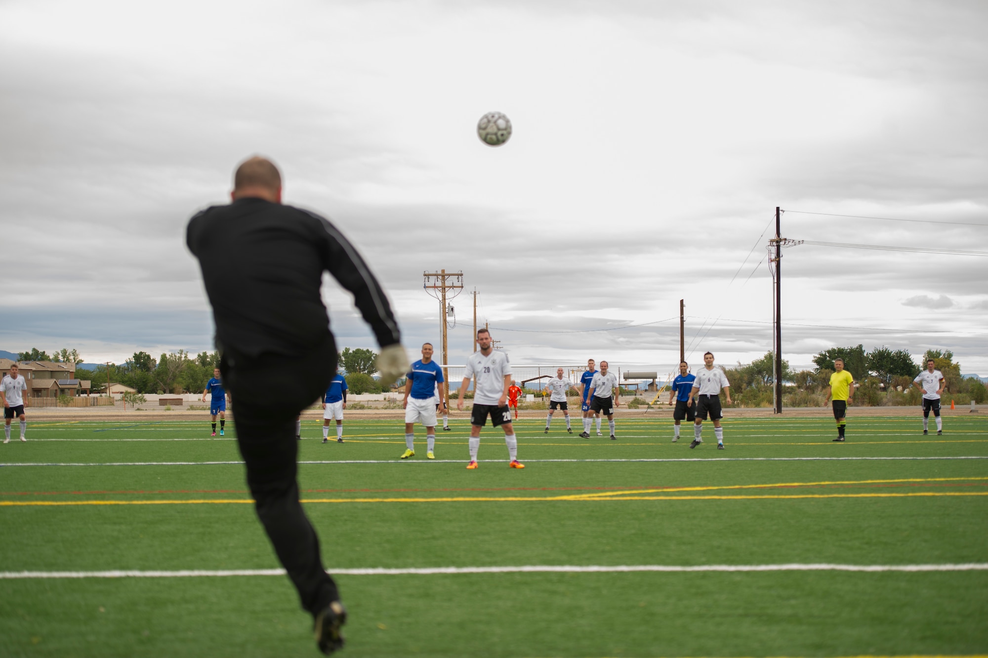 A member of Team Holloman kicks the ball back into play during the annual Oktoberfest International Soccer Match at Holloman Air Force Base, N.M., Sept. 13. Every year the United States Air Force and the German Air Force compete in a soccer match before the Oktoberfest celebration begins. (U.S. Air Force photo by Airman 1st Class Chase Cannon / Released)