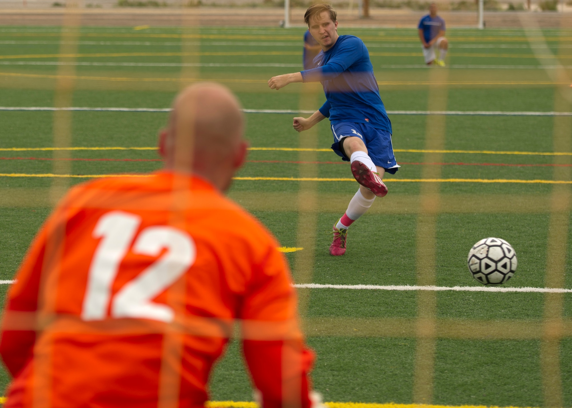 A member of Team Holloman kicks a penalty shot during the annual Oktoberfest International Soccer Match at Holloman Air Force Base, N.M., Sept. 13. Every year the United States Air Force and the German Air Force compete in a soccer match before the Oktoberfest celebration begins. (U.S. Air Force photo by Airman 1st Class Chase Cannon / Released)
