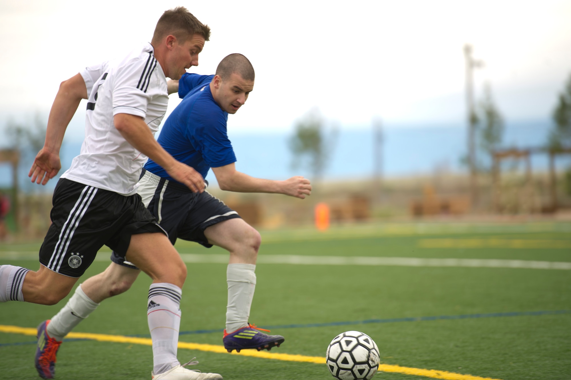 Members of Team Holloman battle for the ball during the annual Oktoberfest International Soccer Match at Holloman Air Force Base, N.M., Sept. 13. Every year the United States Air Force and the German Air Force compete in a soccer match before the Oktoberfest celebration begins. (U.S. Air Force photo by Airman 1st Class Chase Cannon / Released)