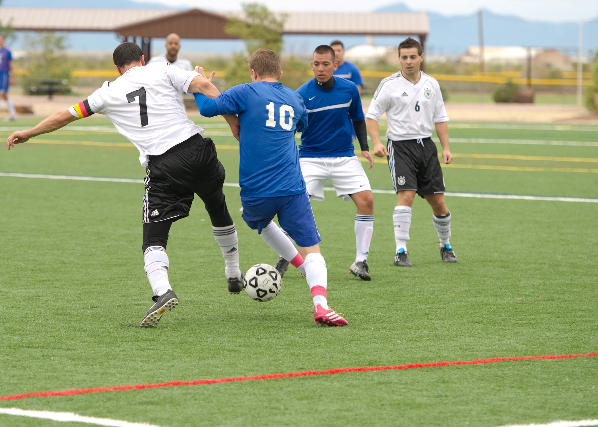 Members of Team Holloman battle for the ball during the annual Oktoberfest International Soccer Match at Holloman Air Force Base, N.M., Sept. 13. Every year the United States Air Force and the German Air Force compete in a soccer match before the Oktoberfest celebration begins. (U.S. Air Force photo by Airman 1st Class Chase Cannon / Released)