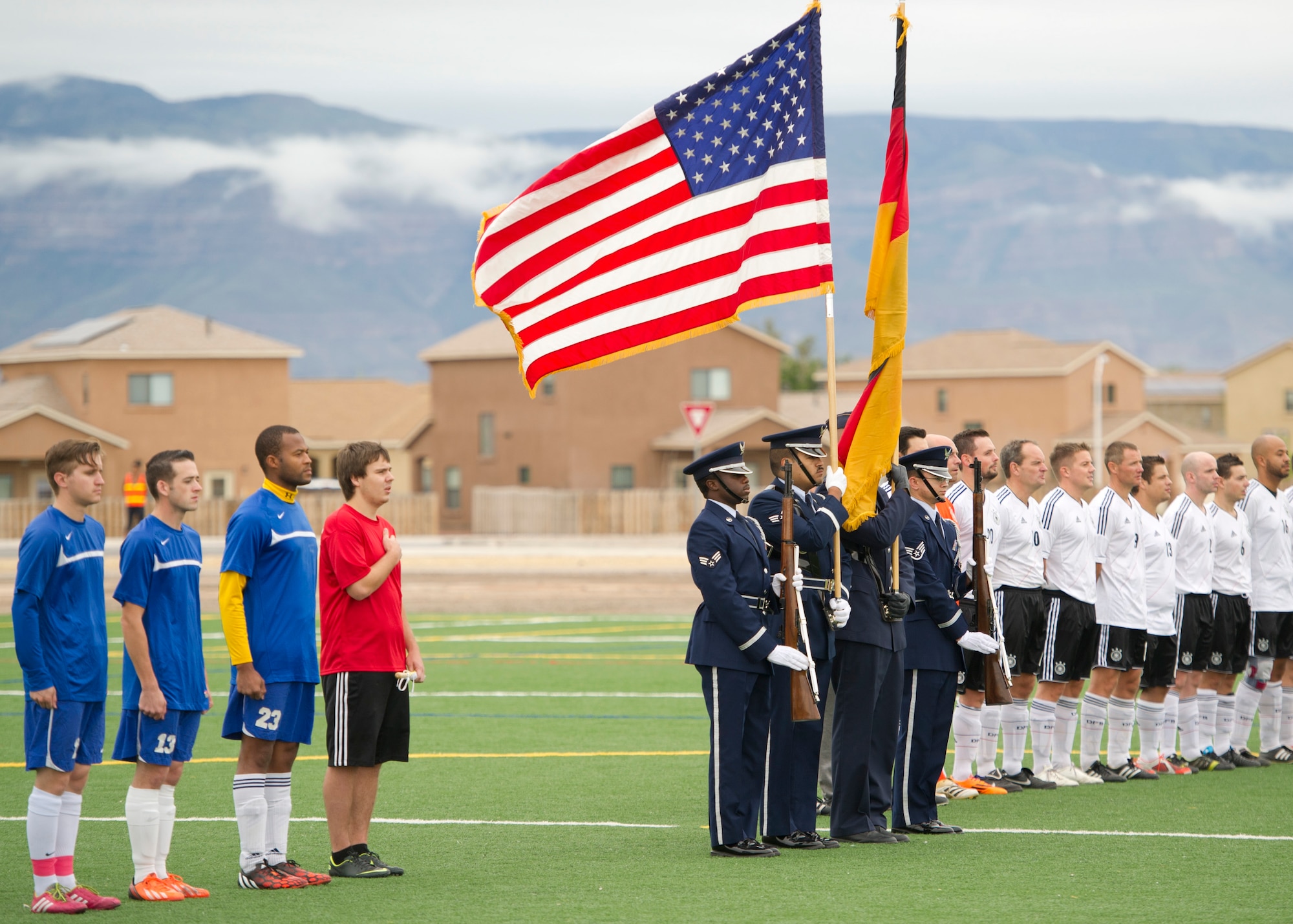 The Steel Talons Honor Guard post the colors during the playing of the U.S. National Anthem before the annual Oktoberfest International Soccer Match at Holloman Air Force Base, N.M., Sept. 13. Every year the United States Air Force and the German Air Force compete in a soccer match before the Oktoberfest celebration begins. (U.S. Air Force photo by Airman 1st Class Chase Cannon / Released)