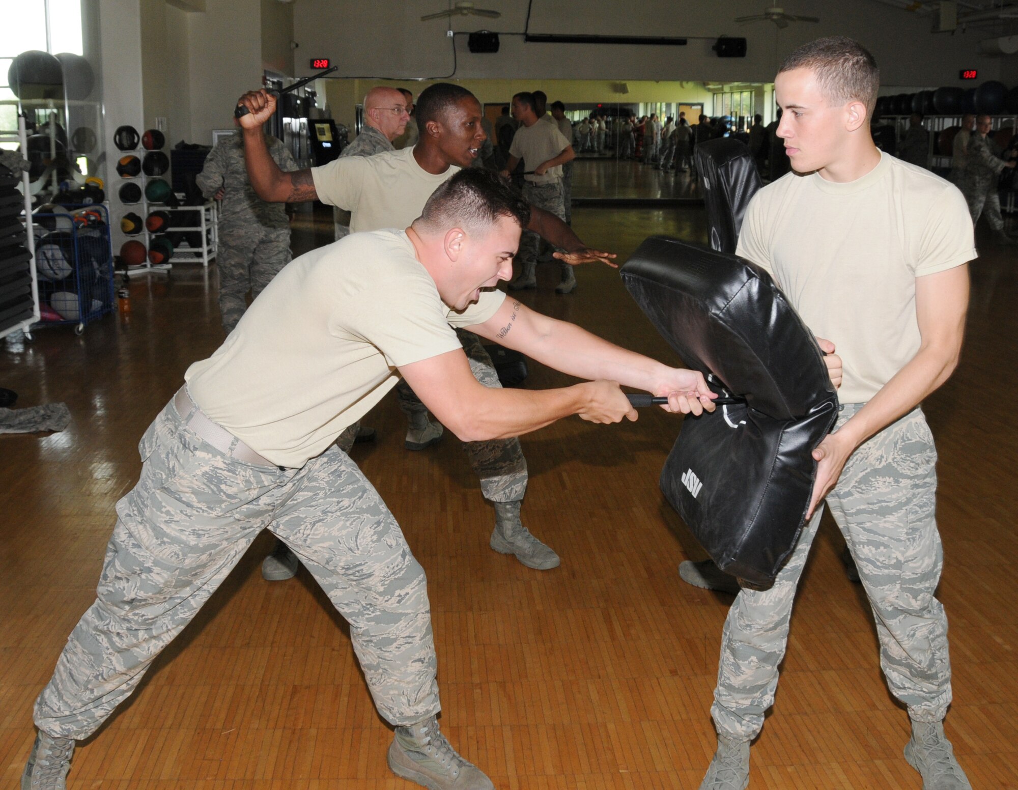 U.S. Air Force Airman 1st Class Thomas G. Lohn, 192nd Fighter Wing Flight Member, and Airman 1st Class Frank Petrine, 192nd FW Flight Member, perform the forward thrust technique with the ASP at Joint Base Langley-Eustis, Virginia August 10, 2014. The Expandable Baton training is an annual training requirement. Airmen are certified for Use of Force, Non-lethal weapons, and practical application of the baton. Thirty-seven members successfully completed the training. (U.S. Air National Guard photo by Captain Craig Carper/Released)