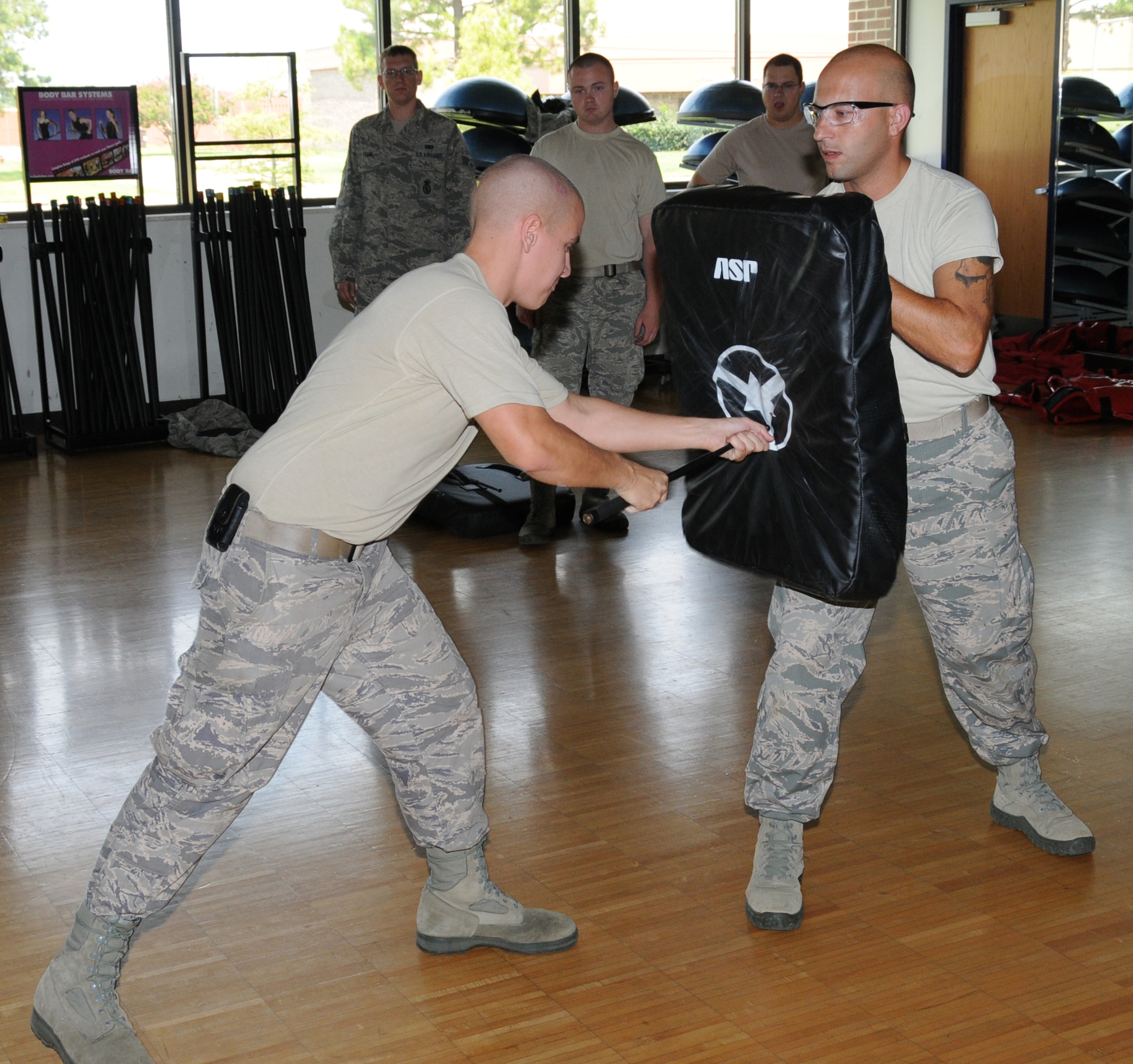 U.S. Air Force Senior Airman Ryan Haulsey (left), 192nd Fighter Wing Security Forces Instructor, demonstrates the forward thrust technique with an expandable baton for the 192nd Fighter Wing Security Forces Flight, with the help of trainee Staff Sgt. Christopher Godin (right), at Joint Base Langley-Eustis, Virginia August 10, 2014. The Expandable Baton training is an annual training requirement. Airmen are certified for Use of Force, Non-lethal weapons, and practical application of the baton. Thirty-seven members successfully completed the training. (U.S. Air National Guard photo by Captain Craig Carper/Released)