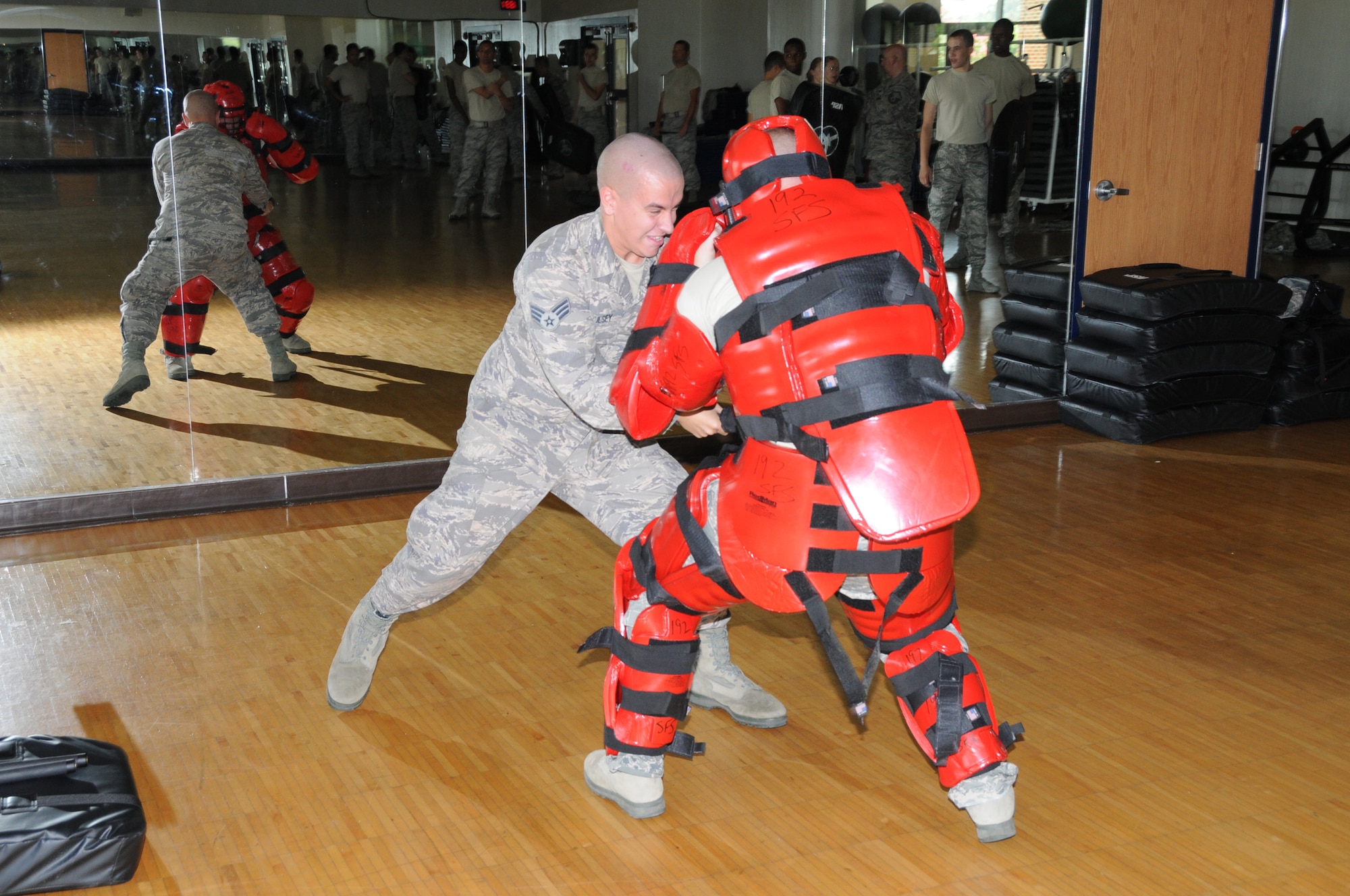 U.S. Air Force Senior Airman Ryan Haulsey (right), 192nd Fighter Wing Security Forces Instructor, and flight member Tech. Sgt. Justin Viars, perform the Red Man drill for the 192nd Security Forces Flight at Joint Base Langley-Eustis, Virginia August 10, 2014. The Red Man drill demonstrates how a security forces officer would defend and ward off an attacking aggressor. (U.S. Air National Guard photo by Captain Craig Carper/Released)
