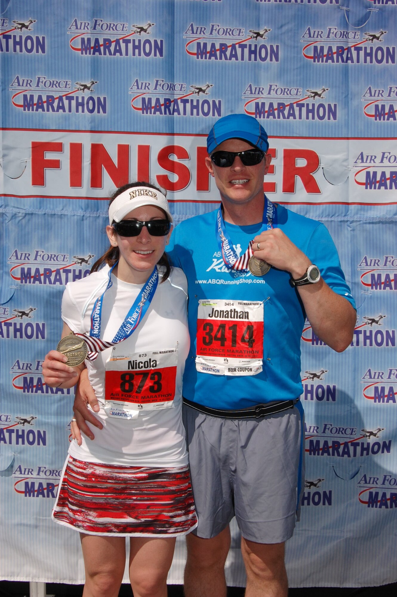 Maj. Jon Phillips, IT enterprise support specialist for the Air Force Inspection Agency, and his wife, Nicola, show off their medals following the 2012 Air Force marathon.  The duo will be running in this year's Air Force marathon Sept. 20 in Dayton, Ohio. (Courtesy photo)