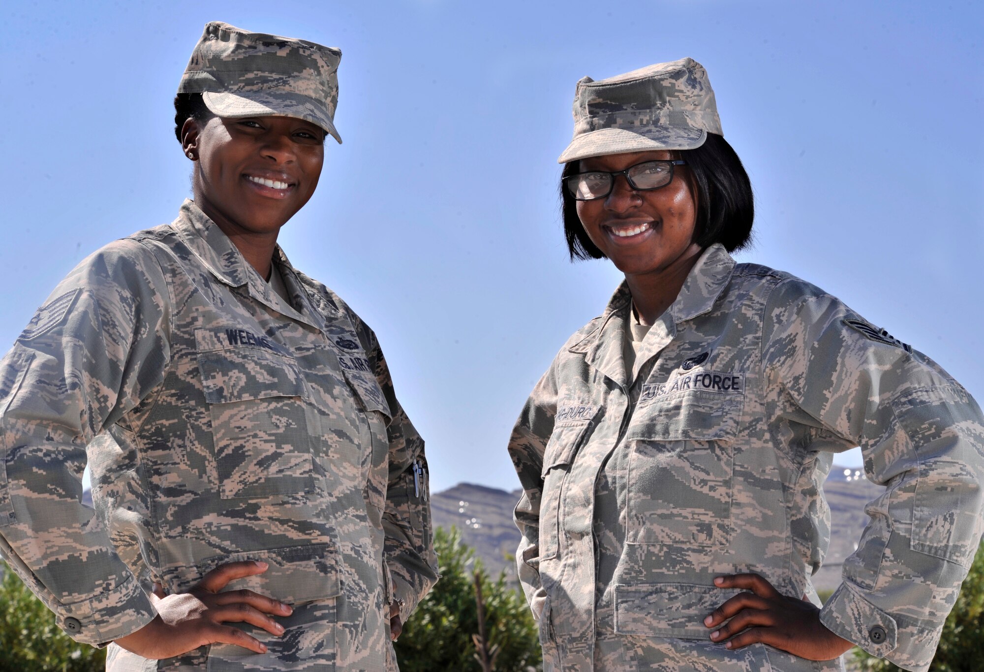 Tech. Sgt. Syreeta Weems, 799th Force Support Squadron NCO in charge of career development, left, and Staff Sgt. Jennifer Obeng-Duro, 799th FSS NCO in charge of retirements/separations, pose for a photo Sept. 11, 2014, at Creech Air Force Base, Nevada. Weems and Obeng-Duro completed over 266 Quality Force Retention Board and Enlisted Retention Board packages while keeping up with major guidance changes, on top of their normal day-to-day duties. Their work ensured that commanders, first sergeants and members had consistent and accurate information during the FY14 force management programs’ implementation. (U.S. Air Force photo by Airman 1st Class Christian Clausen/Released)