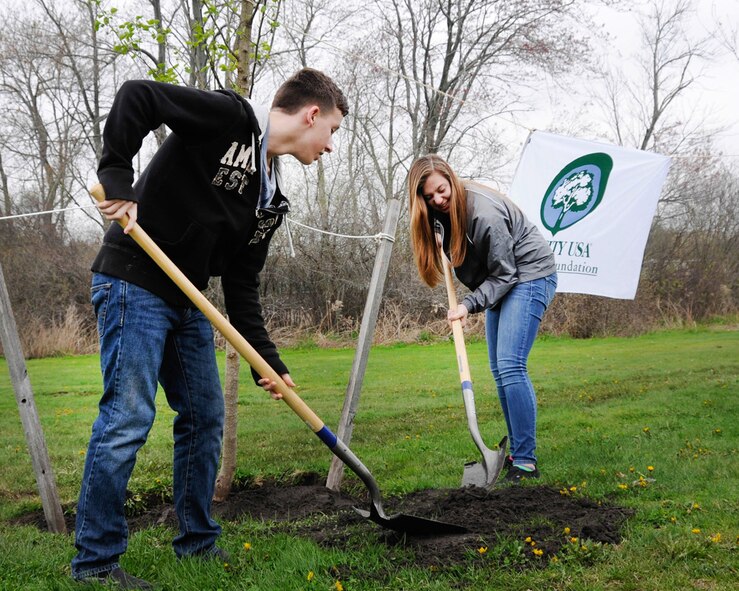 Ty Abbott (left) and Sadie King, Hanscom Middle School students, help plant a tree along Eglin Street near the clinic as part of Arbor Day activities last spring. The nonprofit Arbor Day Foundation has recognized Hanscom’s commitment to urban forestry by naming the base a Tree City USA community for the 27th consecutive year. (U.S. Air Force photo by Linda LaBonte Britt)
