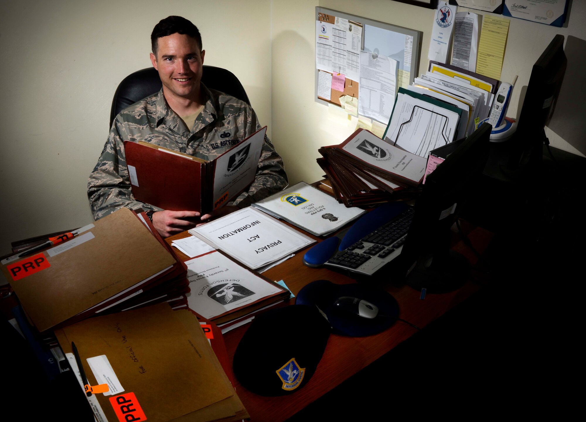Staff Sgt. Colin Vessels, 5th Security Forces Squadron alternate personnel reliability program manager, reviews PRP records in his office on Minot Air Force Base, N.D., Aug. 5, 2014. Before becoming the alternate manager for PRP, and taking charge of the records of approximately 525 Airmen in the 5th SFS, Vessels supervised nine Airmen working in his flight. He stated it is not uncommon for non-commissioned officers in his career field to supervise up to a dozen Airmen at a time. (U.S. Air Force photo/Senior Airman Stephanie Morris)
