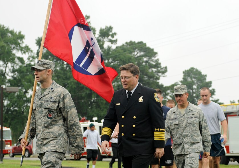 Lt. Col. Eric Rollman, 4th Civil Engineer Squadron commander, carries the 9/11 memorial flag during the 9/11 Remembrance Run at Seymour Johnson Air Force Base, North Carolina, Sep. 12. Members of Team Seymour ran continuously with the 9/11 memorial flag for 24 hours. The run began at 9 a.m. when the fire department’s youngest firefighter left the firehouse carrying the flag and ended when the oldest, Sean Quinby, 4th CES fire chief, returned it 24 hours later. Participants racked up a combined total of 1,397 miles ran. (U.S. Air Force photo/Airman 1st Class Aaron Jenne)