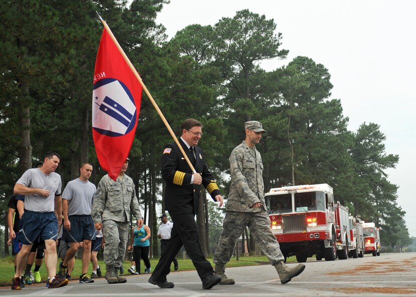 Sean Quinby, 4th Civil Engineer Squadron fire chief, carries the 9/11 memorial flag during the 9/11 Remembrance Run at Seymour Johnson Air Force Base, North Carolina, Sept. 12. Members of Team Seymour ran continuously with the 9/11 memorial flag for 24 hours. The run began at 9 a.m. when the fire department’s youngest firefighter left the firehouse carrying the flag and ended when the oldest, Quinby, returned it 24 hours later. Participants racked up a combined total of 1,397 miles ran. (U.S. Air Force photo/Airman 1st Class Aaron Jenne) 
