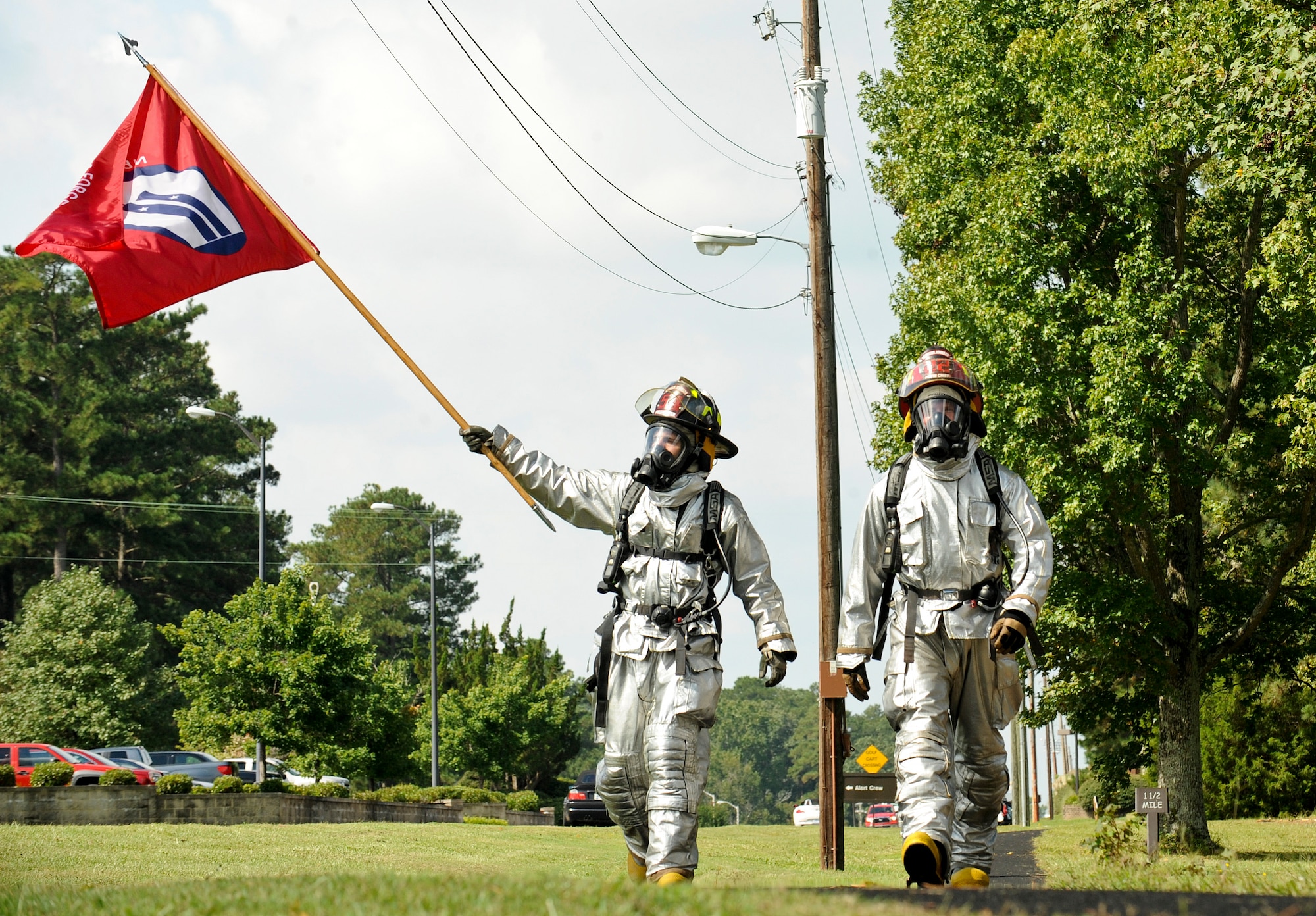 Senior Airman Christopher Parker (left) parker and Tech. Sgt. Jeremy Luedtke, both of the 4th Civil Engineer Squadron fire department, with the 9/11 memorial flag during the 9/11 Remembrance Run at Seymour Johnson Air Force Base, North Carolina, Sep. 11. Members of Team Seymour ran continuously with the 9/11 memorial flag for 24 hours. The run began at 9 a.m. when the fire department’s youngest firefighter left the firehouse carrying the flag and ended when the oldest, Sean Quinby, 4th CES fire chief, returned it 24 hours later. Participants racked up a combined total of 1,397 miles ran. (U.S. Air Force photo/Airman 1st Class Aaron Jenne)