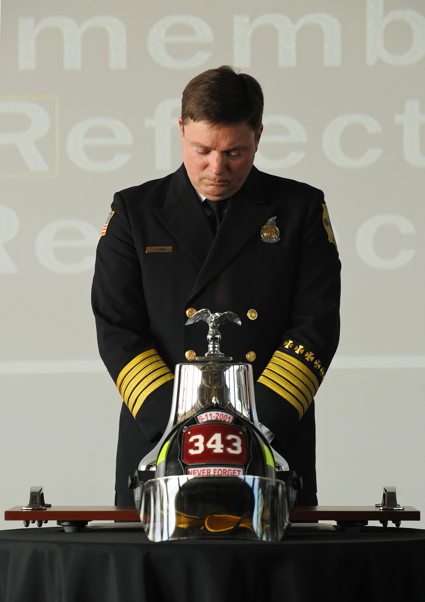 A moment of silence before Sean Quinby, 4th Civil Engineer Squadron fire chief, rings the fire bell, paying homage to the lives lost on 9/11 during the 9/11 Remembrance Ceremony at Seymour Johnson Air Force Base, North Carolina, Sep. 11. The event, hosted by the 4th Fighter Wing honor guard, 4th CES and the 4th Security Forces Squadron, featured narrators recounting the sequence of events on 9/11, a firing party, and moments of silent reflection. (U.S. Air Force photo/Airman 1st Class Aaron Jenne)