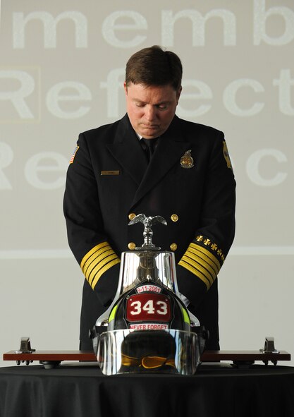 A moment of silence before Sean Quinby, 4th Civil Engineer Squadron fire chief, rings the fire bell, paying homage to the lives lost on 9/11 during the 9/11 Remembrance Ceremony at Seymour Johnson Air Force Base, North Carolina, Sep. 11. The event, hosted by the 4th Fighter Wing honor guard, 4th CES and the 4th Security Forces Squadron, featured narrators recounting the sequence of events on 9/11, a firing party, and moments of silent reflection. (U.S. Air Force photo/Airman 1st Class Aaron Jenne)