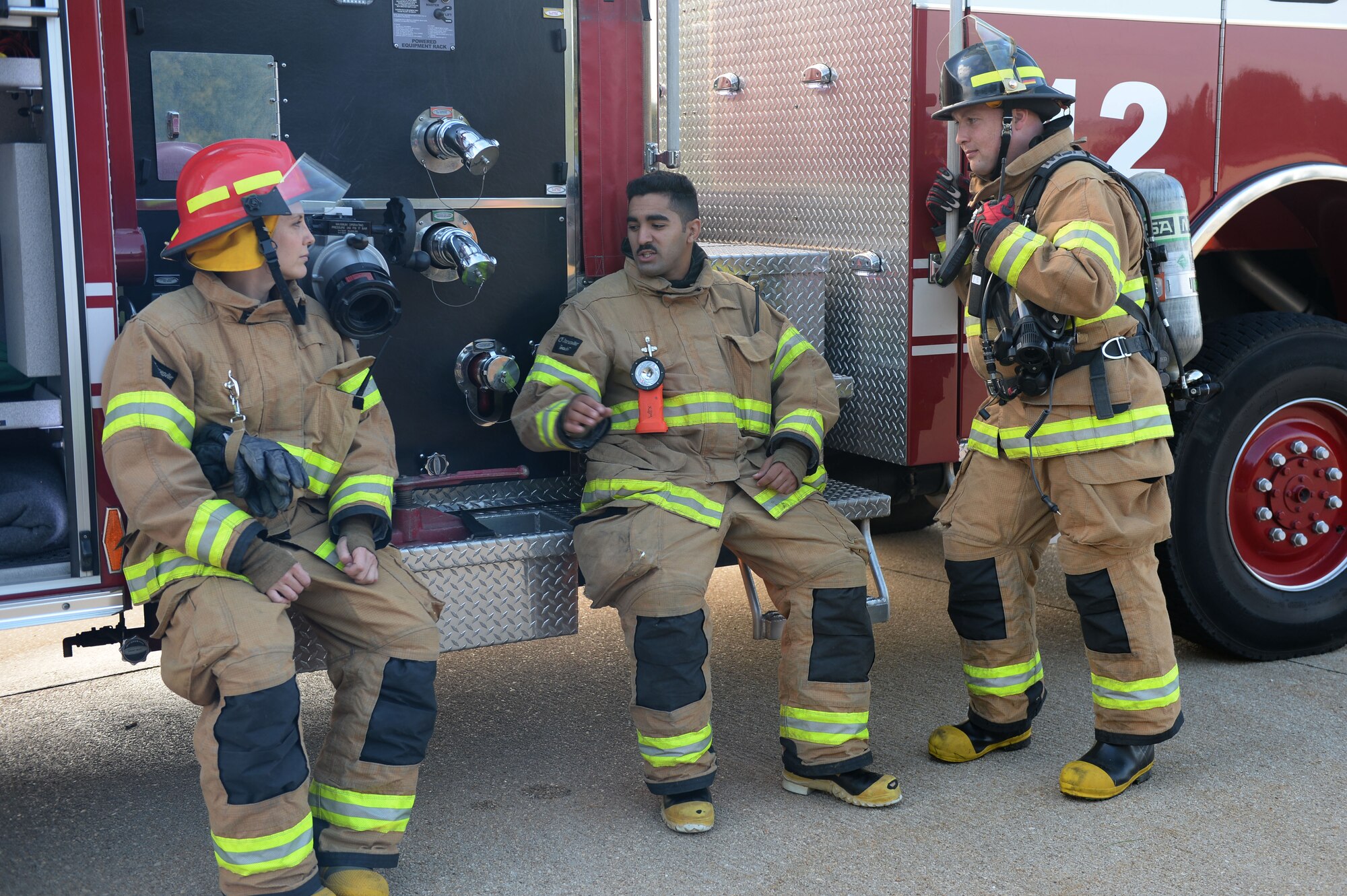 U.S. Air Force firefighters from the 52nd Civil Engineer Squadron relax after the completion of a fuel spill exercise Sept. 12, 2014, at Spangdahlem Air Base, Germany. Firefighters constantly train to be prepared for any emergency. (U.S. Air Force photo by Airman 1st Class Dylan Nuckolls/Released)