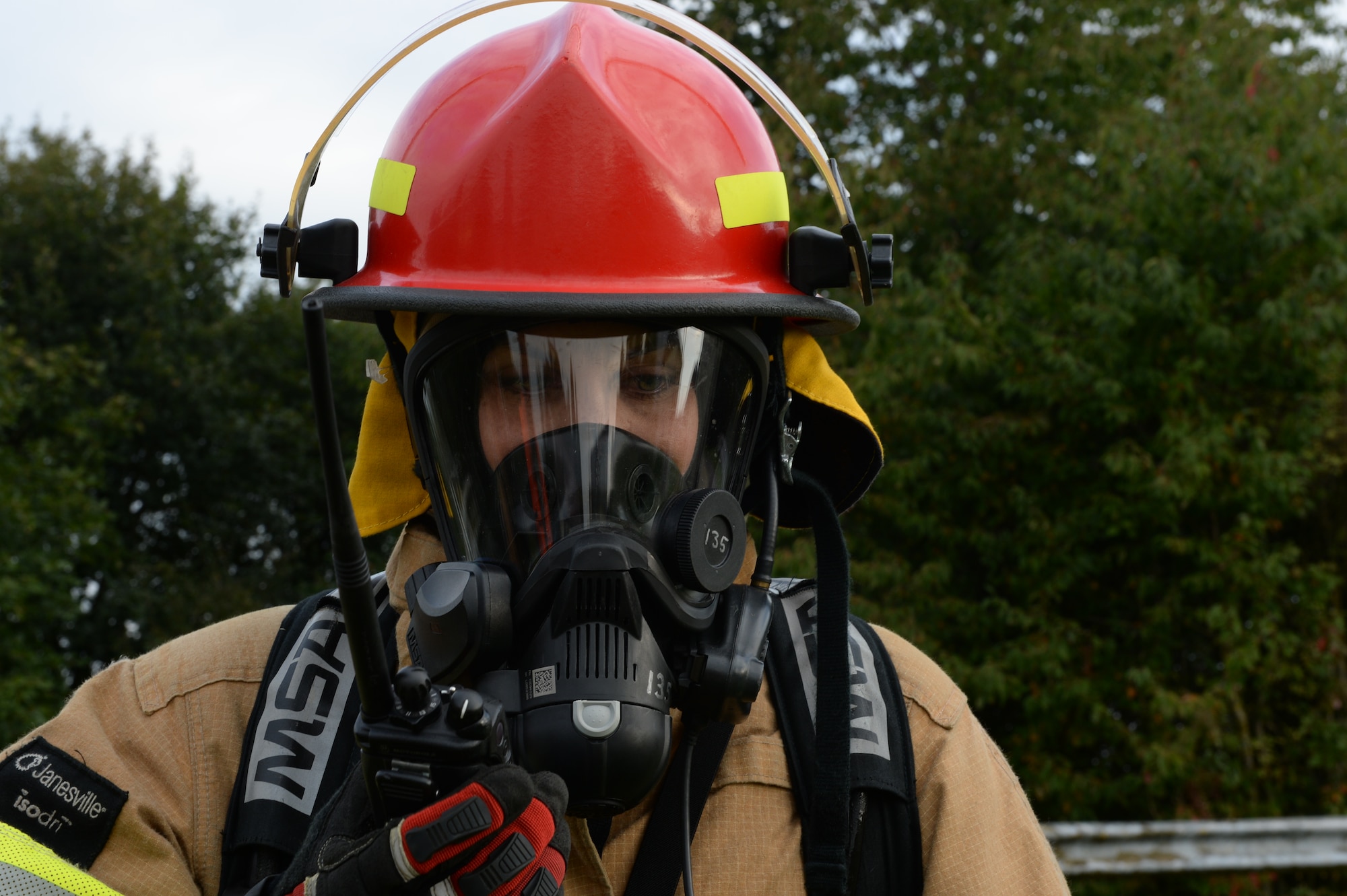 U.S. Air Force Staff Sgt. Jessica Morgan, a 52nd Civil Engineer Squadron firefighter from Chicago, communicates through a radio during a fuel spill exercise Sept. 12, 2014, at Spangdahlem Air Base, Germany. The exercise tested the skills of the base’s responders to ensure a quick response to a fuel spill. (U.S. Air Force photo by Airman 1st Class Dylan Nuckolls/Released)