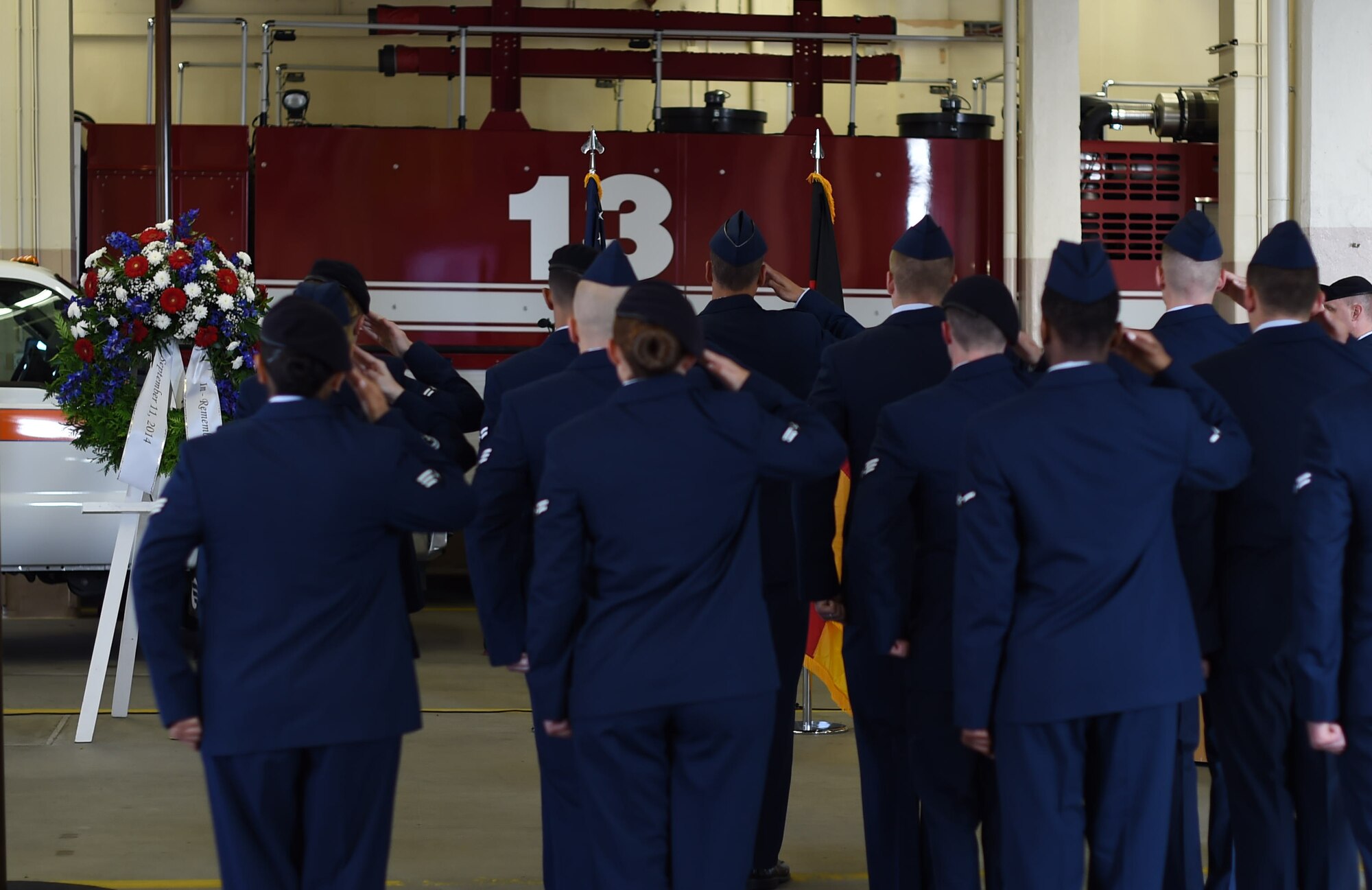 Members of Team Ramstein render a salute during a 9/11 ceremony at Fire Station One on Ramstein Air Base, Germany, Sept. 11, 2014. The ceremony was held to honor the first responders who lost their lives at the World Trade Center 13 years ago. (U.S. Air Force photo/Senior Airman Damon Kasberg)