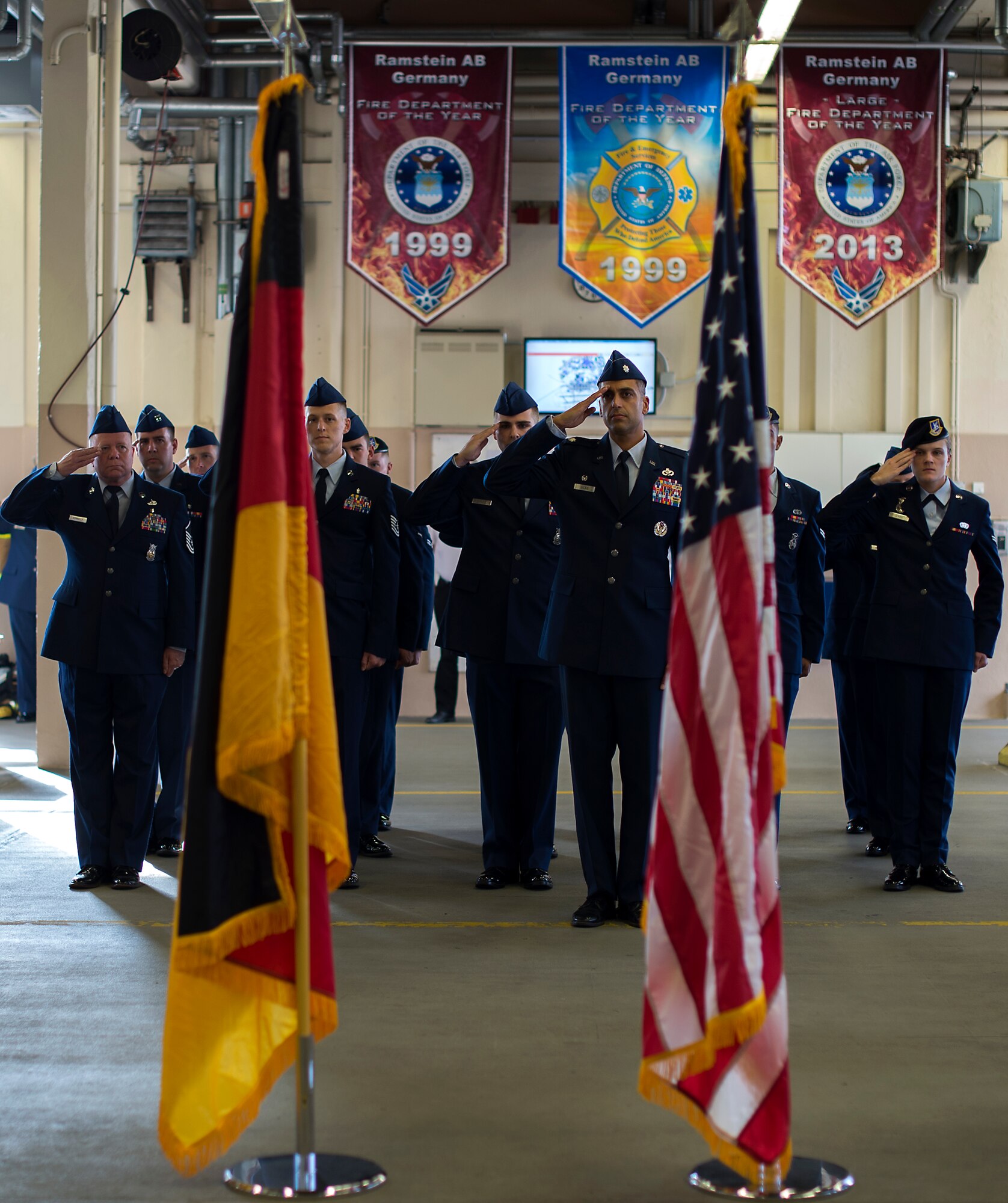Members of Team Ramstein render a salute during a 9/11 ceremony at Fire Station One on Ramstein Air Base, Germany, Sept. 11, 2014. The ceremony was held to honor the first responders who lost their lives at the World Trade Center 13 years ago. (U.S. Air Force photo/Senior Airman Damon Kasberg)