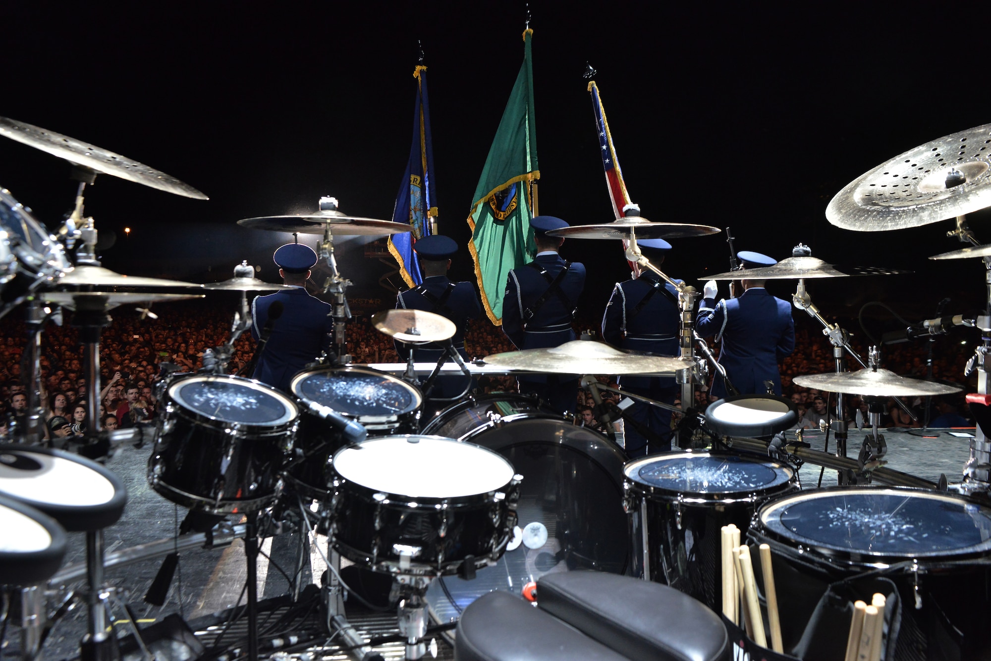Members from the Fairchild Air Force Base honor guard present the colors on stage for thousands of fans during the “Rock Hard at the Park” concert tour Sept. 11, 2014, in Post Falls, Idaho. The concert highlighted multiple rock bands and had a special patriotic ceremony to highlight Sept. 11. (U.S. Air Force photos by Staff Sgt. Alexandre Montes/Released)