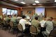 Chief Master Sgt. Martha Garcia, 161st Air Refueling Wing command chief, explains an Air Force organizational chart during an NCO information exchange Sept. 9, 2014. The Arizona Air National Guard welcomed seven members of the Kazakhstan military Sept. 8 through 12, 2014, as part of the National Guard's State Partnership Program. The program is designed as an information exchange with the purpose of fostering mutual interests and long-term relationships. (U.S. Air National Guard photo by 2nd Lt. Susan Gladstein/Released)