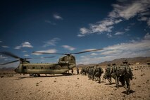 FORT IRWIN, Calif. – U.S. Army Soldier's assigned to the 3rd Squadron 17th Regiment Delta company load onto a chinook helicopter during Decisive Action Rotation 14-09 at the National Training Center, Aug. 10, 2014. Decisive action rotations are reflective of the complexities of potential adversaries our nation could face and include: guerilla, insurgent, criminal and near-peer conventional forces woven into one dynamic environment. (U.S. Air Force Photo by Staff Sgt. Corey Hook/Released)